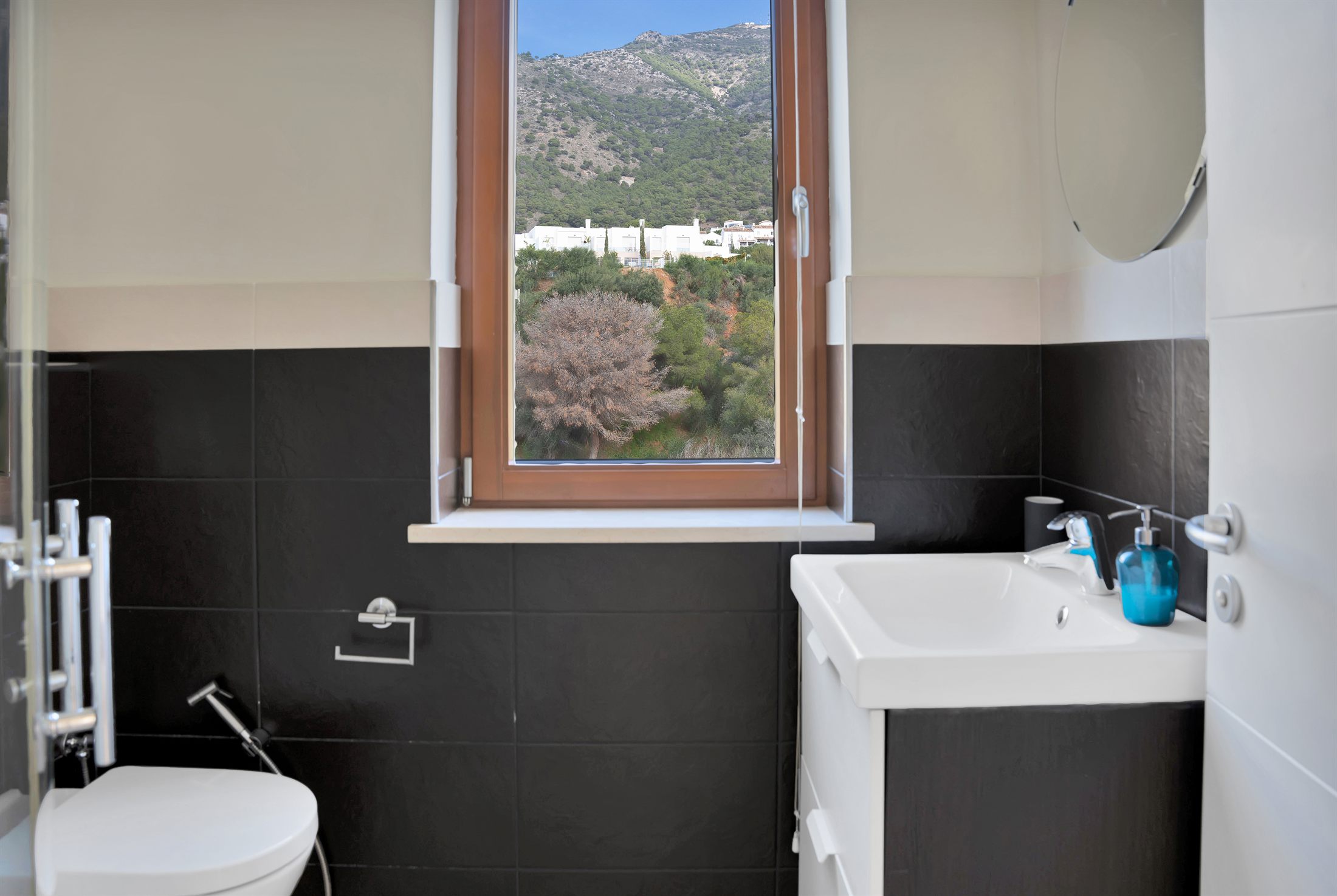 Bathroom with dark tiling
