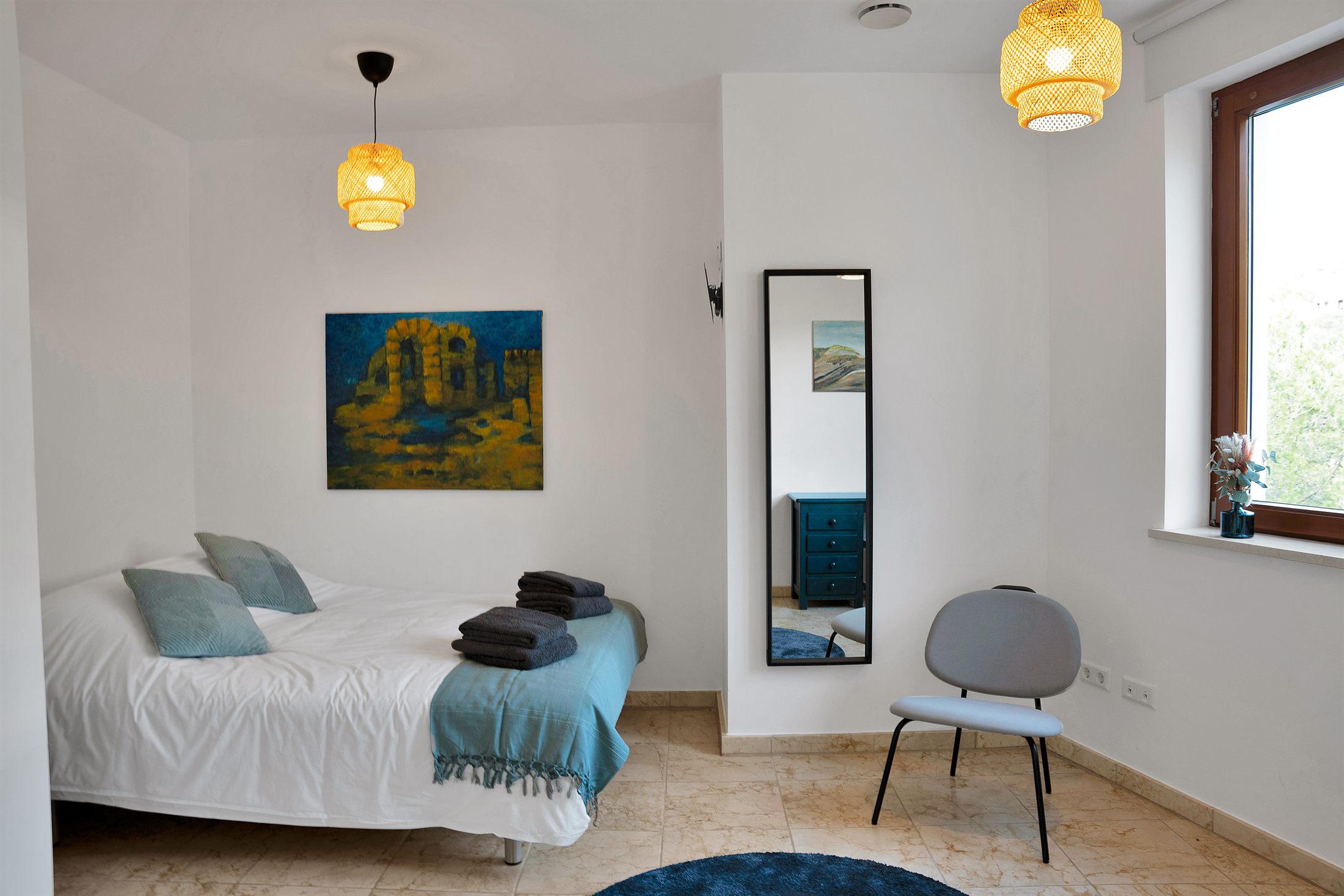Bedroom with mirror and armchair