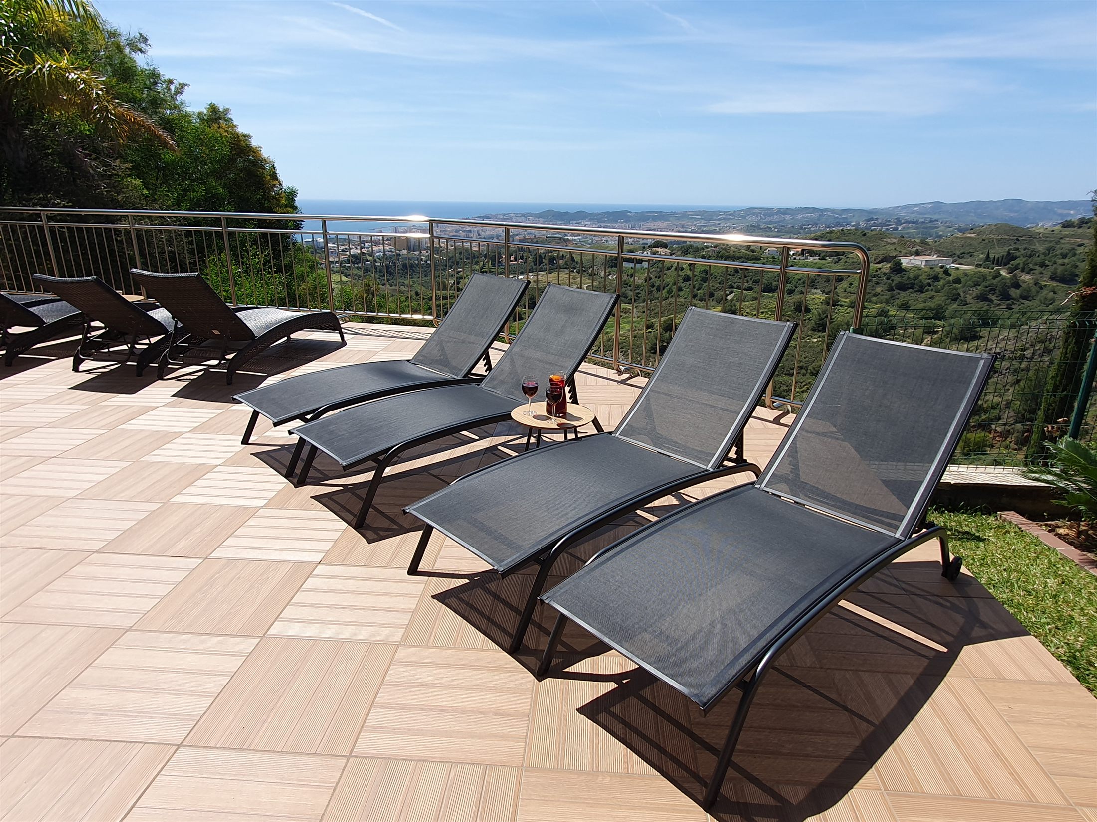 Terrace loungers with coastal view